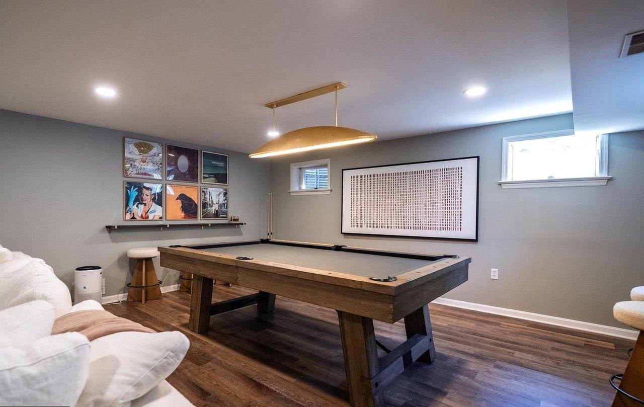 Lower-level lounge with a billiards table and sectional sofa